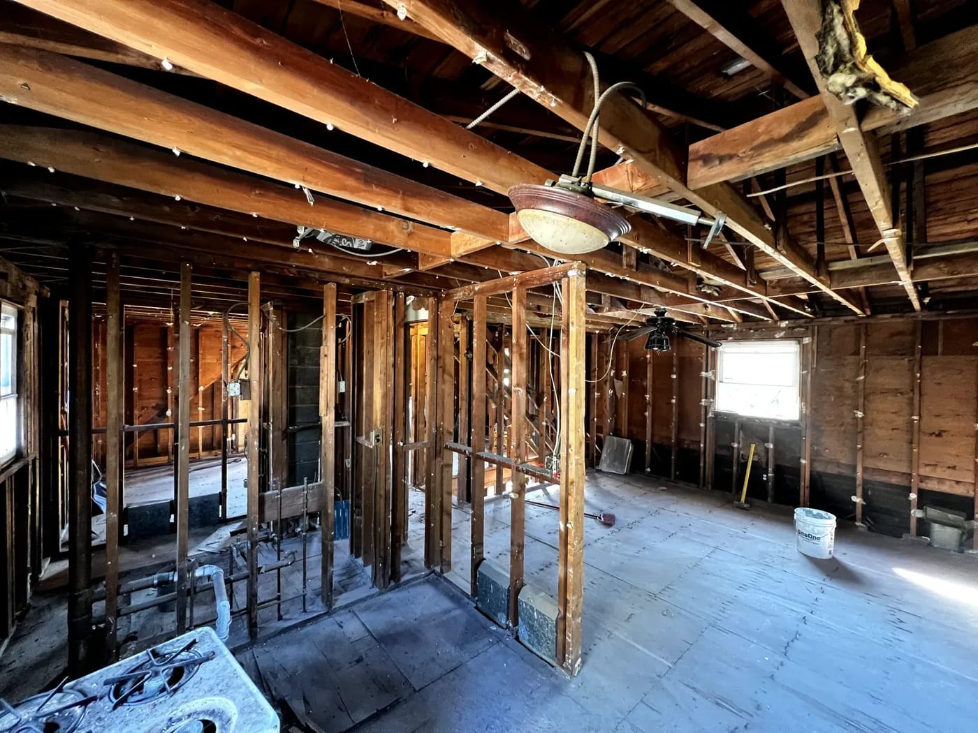 Interior stripped to the studs after light demolition, drywall and ceiling removed
